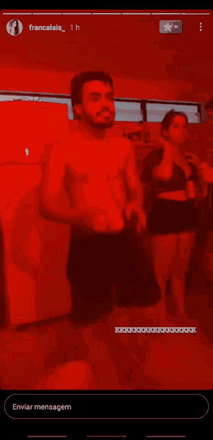 a man without a shirt is holding a cup in front of a white refrigerator