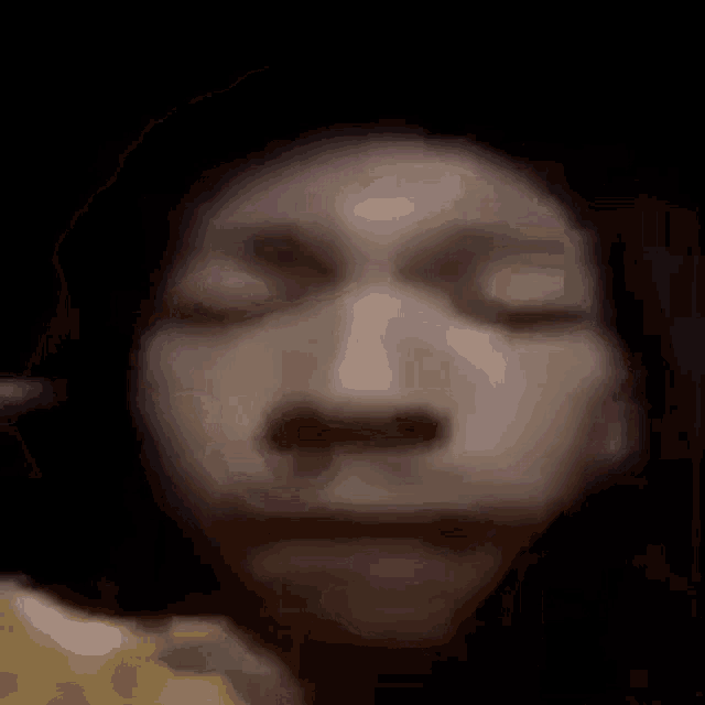 a close up of a person 's face with their eyes closed and a pink lip .
