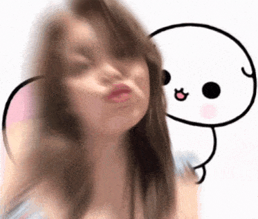 a blurry picture of a woman making a face with a cartoon character behind her