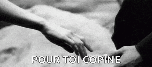 a black and white photo of two people holding hands with the words `` pour toi copine '' .