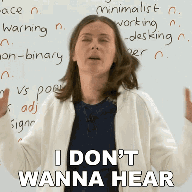 a woman says i don 't wanna hear while standing in front of a whiteboard
