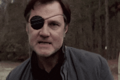 a man with a bandage on his eye looks angry