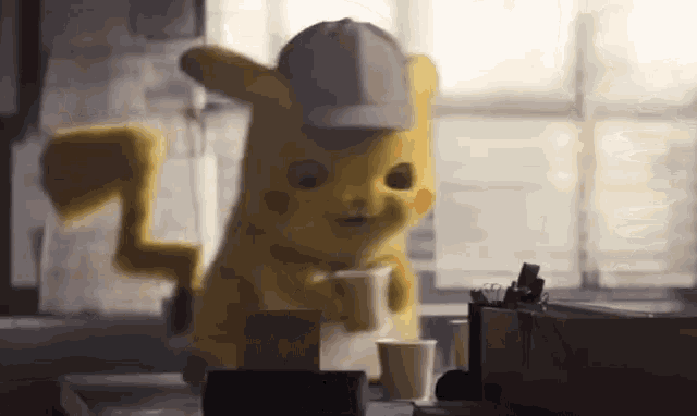 a pikachu mascot is holding a cup of coffee in his hand .