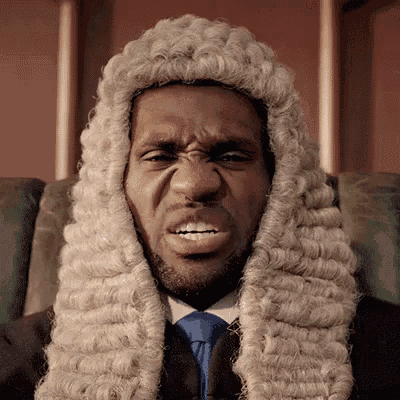a man is wearing a wig and tie and making a face