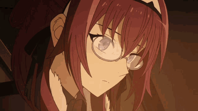 a girl with red hair and glasses is looking at the camera