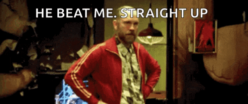 a man in a red jacket with the words he beat me straight up below him
