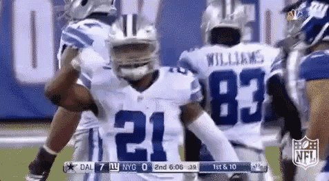 a group of cowboys football players are celebrating a touchdown during a game .