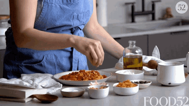 a woman prepares food in a kitchen with the number 52 on the corner