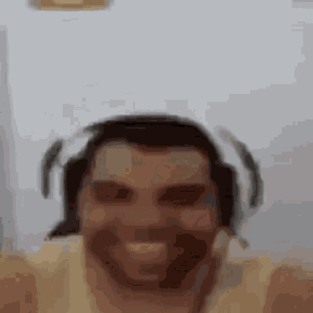 a man wearing headphones is taking a selfie .