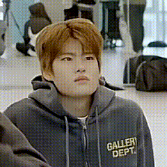 a young man wearing a grey hoodie with the words gallery dept. on it