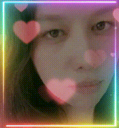 a woman 's face is surrounded by pink hearts and a rainbow colored frame