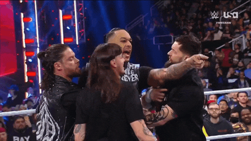 a group of men are standing next to each other in a ring .