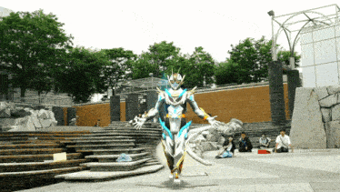 a man in a white and blue costume stands in front of stairs