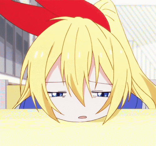 a girl with blonde hair and a red bow on her head is making a sad face