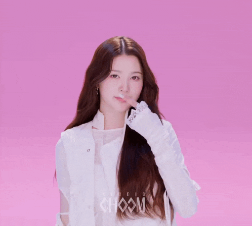 a woman with long hair is wearing a white jacket that says choom studio