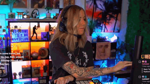 a woman wearing headphones and a microphone is playing a music track