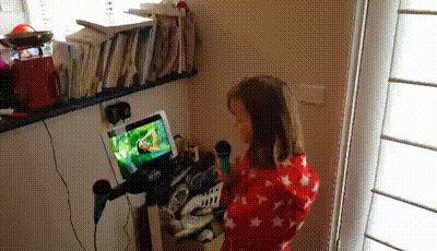 a girl is singing into a microphone in front of a screen that says ' off '