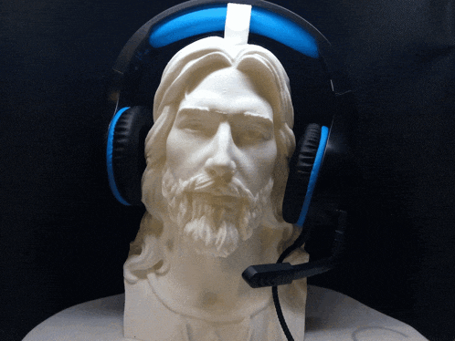 a statue of jesus wearing headphones with a microphone