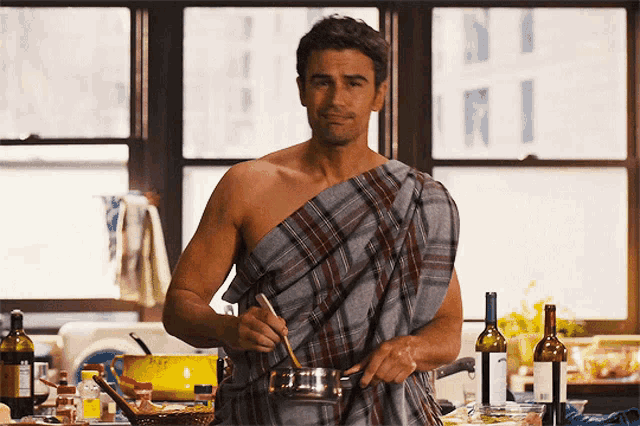 a shirtless man in a plaid towel stirs a pot