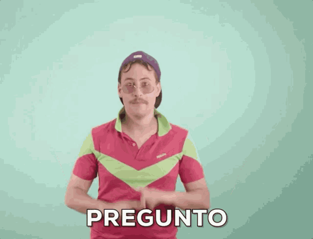 a man wearing sunglasses and a hat is pointing up with the word pregunto written on the screen behind him .