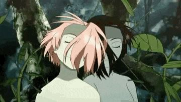 a man and a woman are hugging each other in a forest .