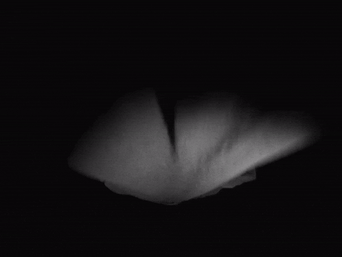 a man in a black robe holds his head in his hands