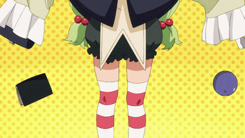 a girl with green hair and red and white striped socks stands in front of a yellow polka dot background