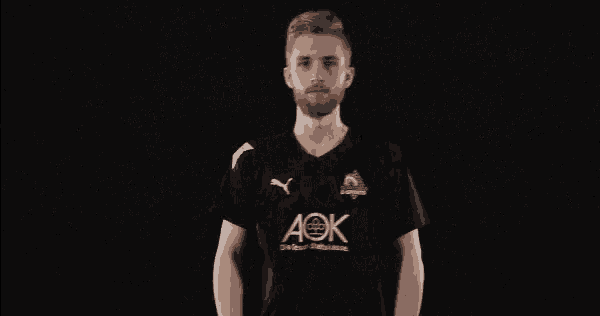 a man wearing a black shirt with aok written on it