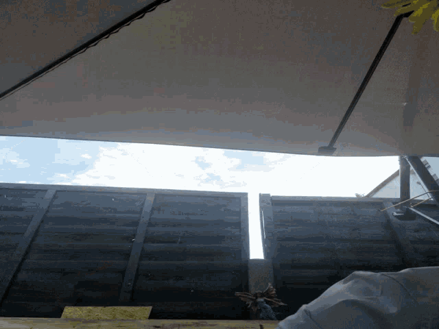 looking up at a blue sky with a white umbrella in the foreground