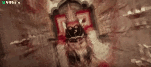 a statue of a man with a mask on his face is laying on a bed .