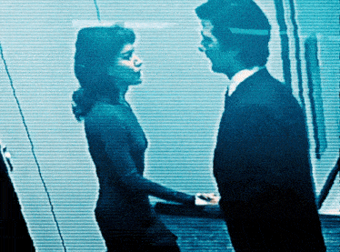 a man and a woman are looking at each other