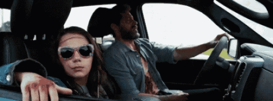 a man and a girl are sitting in a car