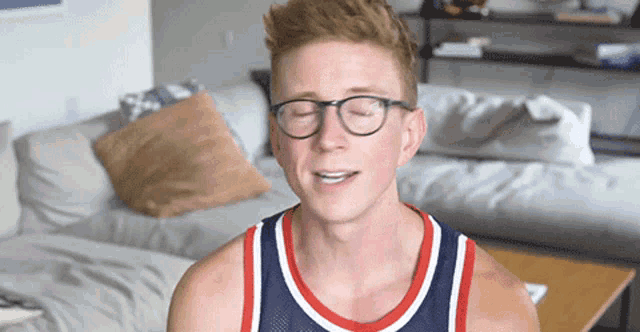a man wearing glasses and a basketball jersey
