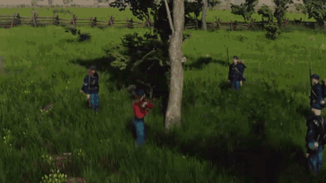 a group of soldiers standing in a grassy field with a fence in the background