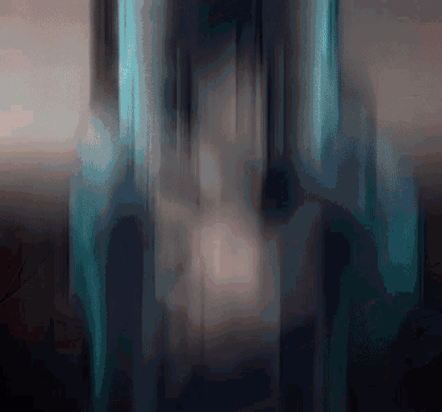 a blurred image of a building with a blue light coming out of the bottom