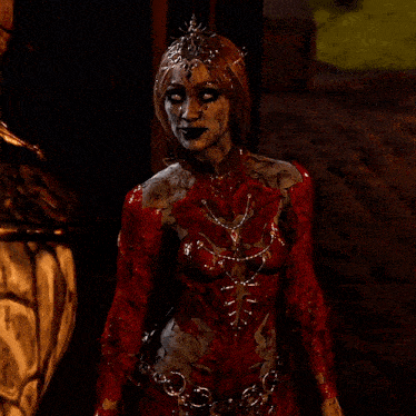 a woman in a red bodysuit with chains around her waist and a crown on her head