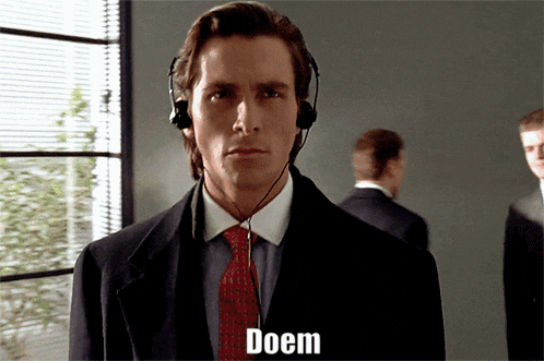 a man wearing a suit and tie with a headset on says doem