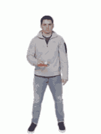 a man is standing in front of a white background and holding a bottle of soda .