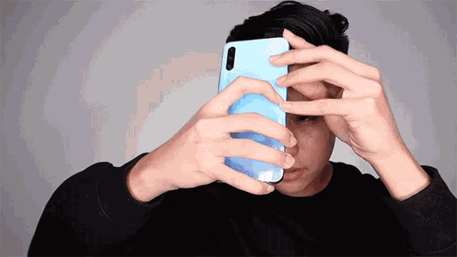 a man is taking a picture of himself with a cell phone