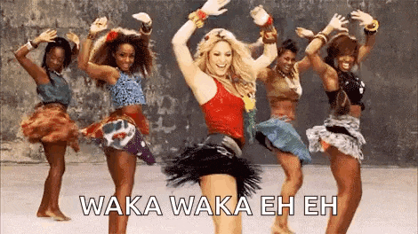 a group of women are dancing together in a video with the words waka waka eh eh on the bottom .