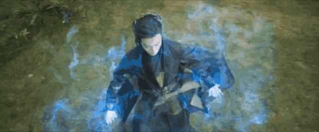 a person in a blue cape is surrounded by blue light