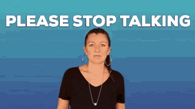 a woman in a black shirt is making a stop talking gesture
