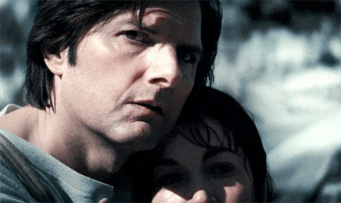 a man and a woman are looking at the camera