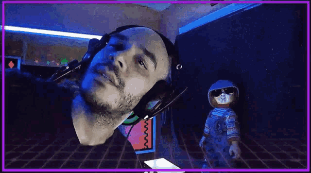 a man wearing headphones and sunglasses is looking at a doll in a room .