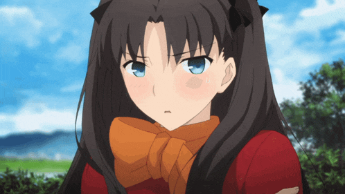 a girl with long dark hair and blue eyes is wearing a red shirt and an orange scarf