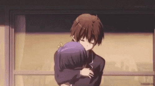 a man and a woman are hugging each other in a room .