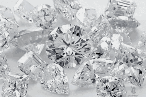 a bunch of different shaped diamonds are laying on a white surface