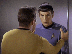two men standing next to each other with one wearing a star trek uniform