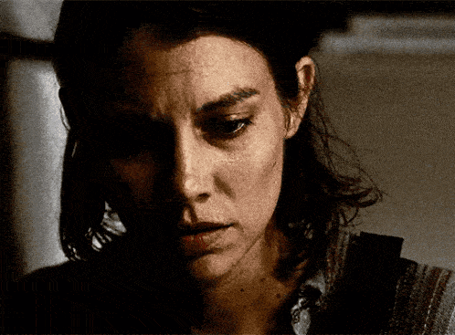 a close up of a woman 's face with a sad look on her face .