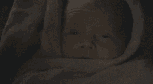 a close up of a man 's face in the dark .